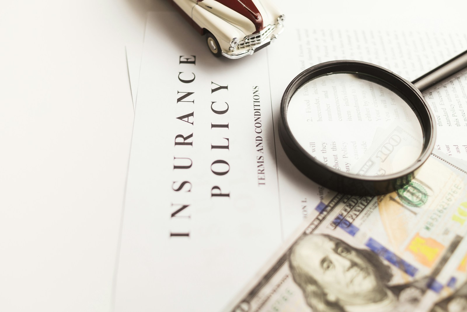 a magnifying glass sitting on top of a car insurance